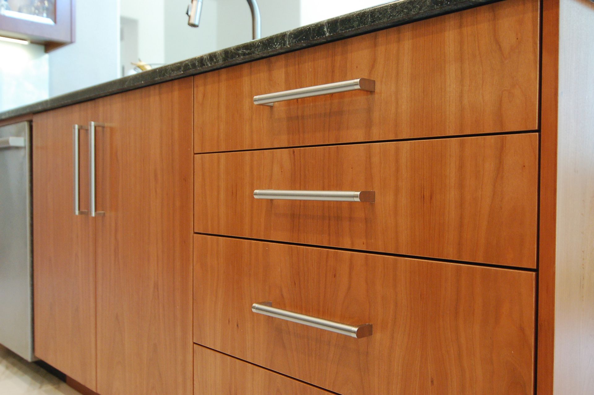 A kitchen with wooden cabinets and stainless steel appliances
