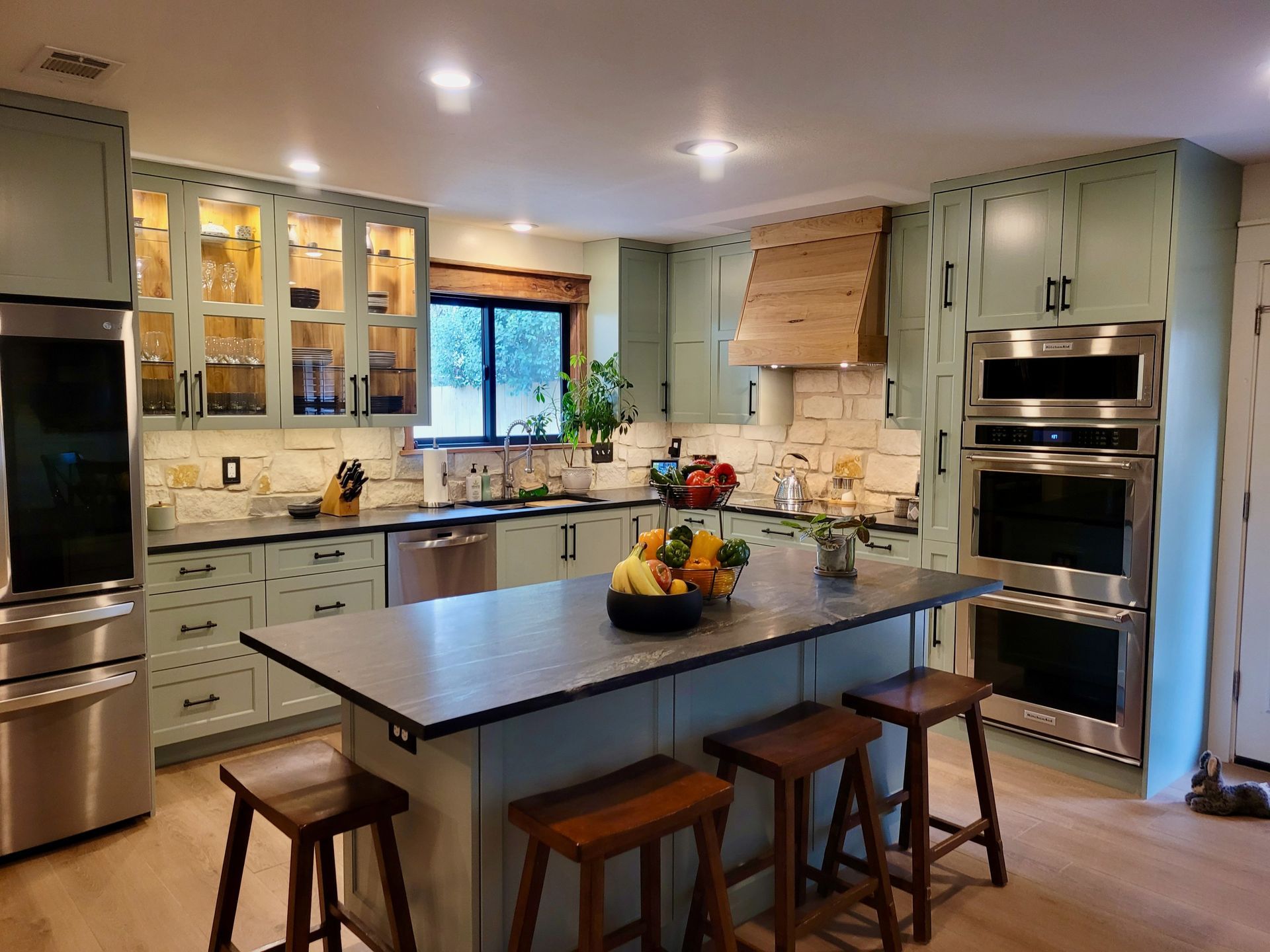A kitchen with stainless steel appliances and a large island.