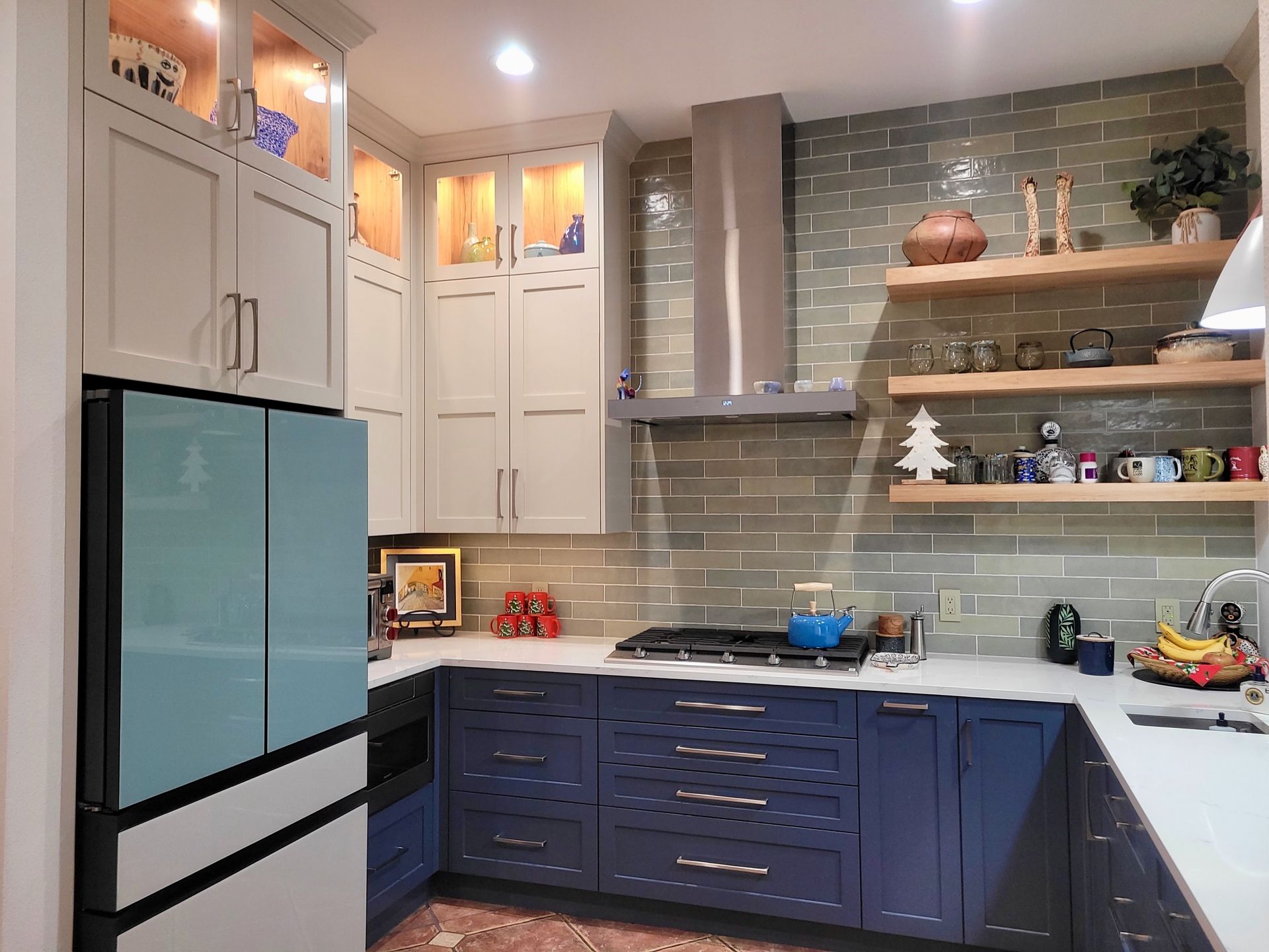 A kitchen with blue cabinets and white counter tops