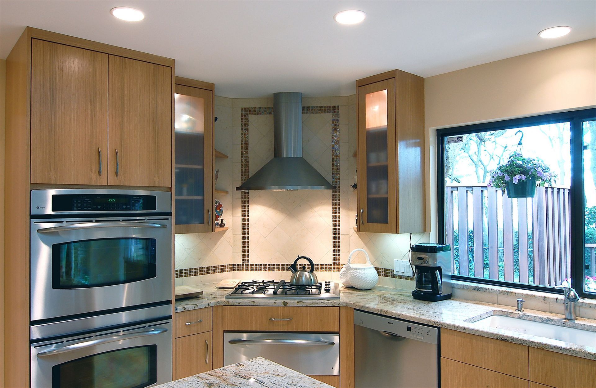 A kitchen with stainless steel appliances and wooden cabinets