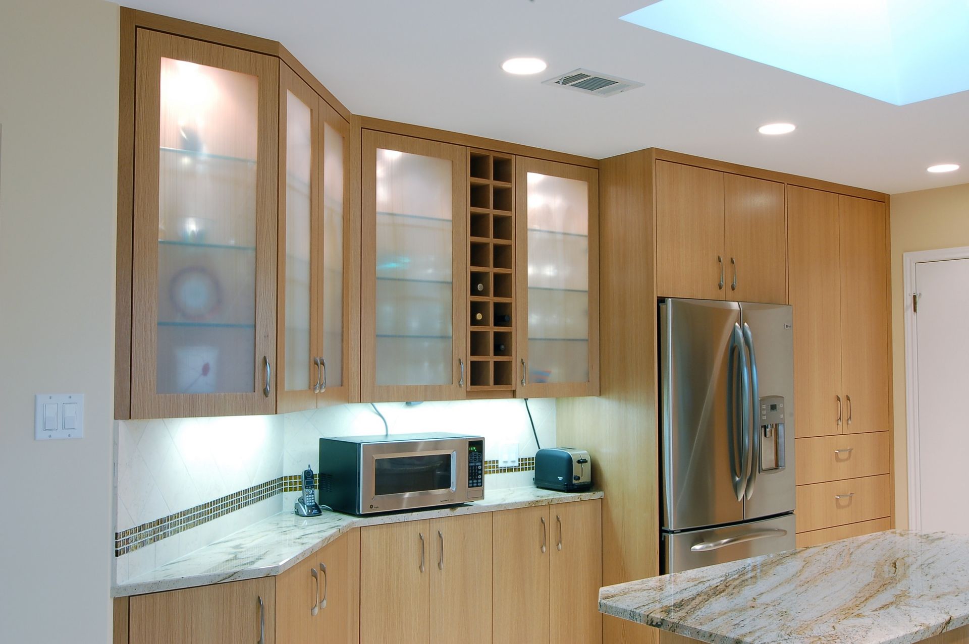 A kitchen with stainless steel appliances and wooden cabinets