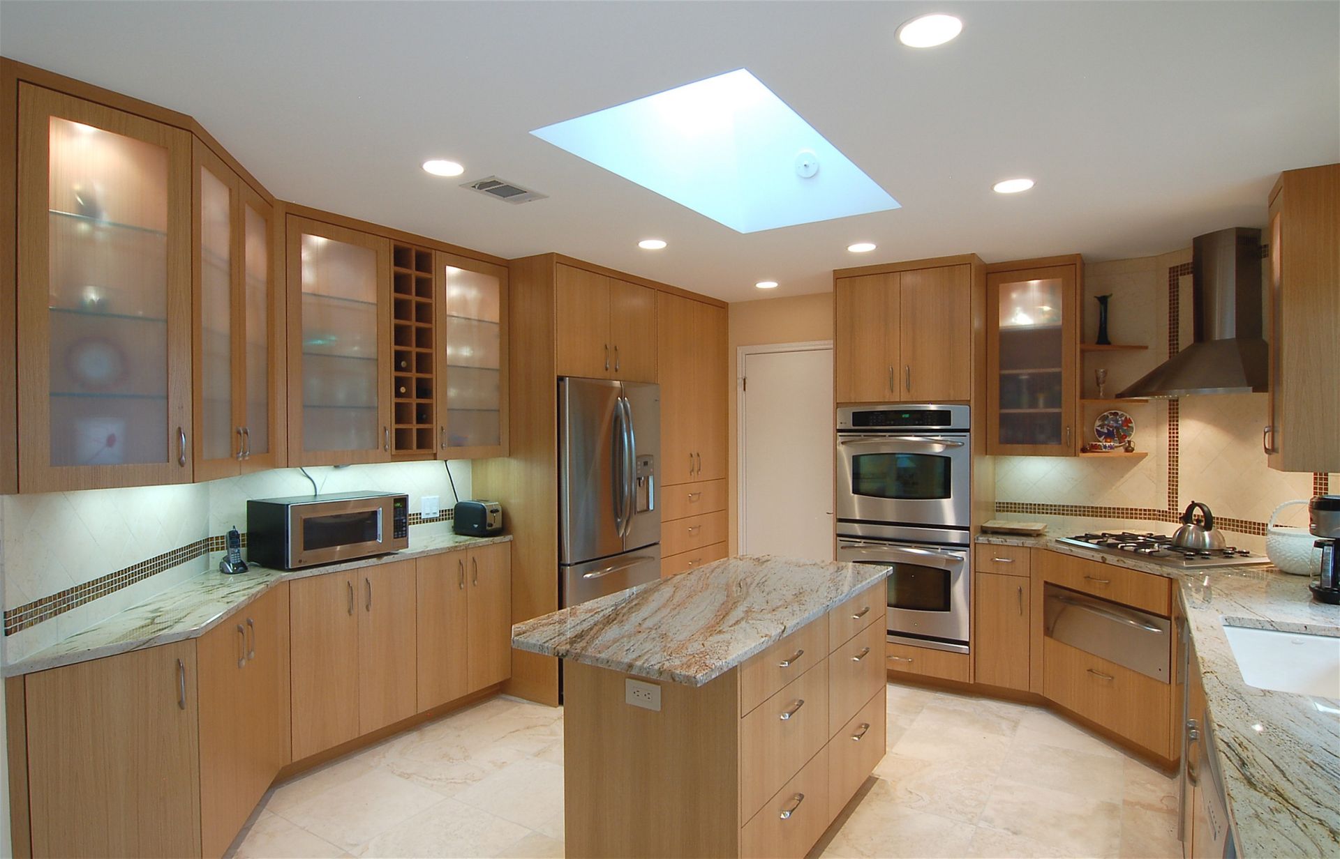 A kitchen with stainless steel appliances and wooden cabinets