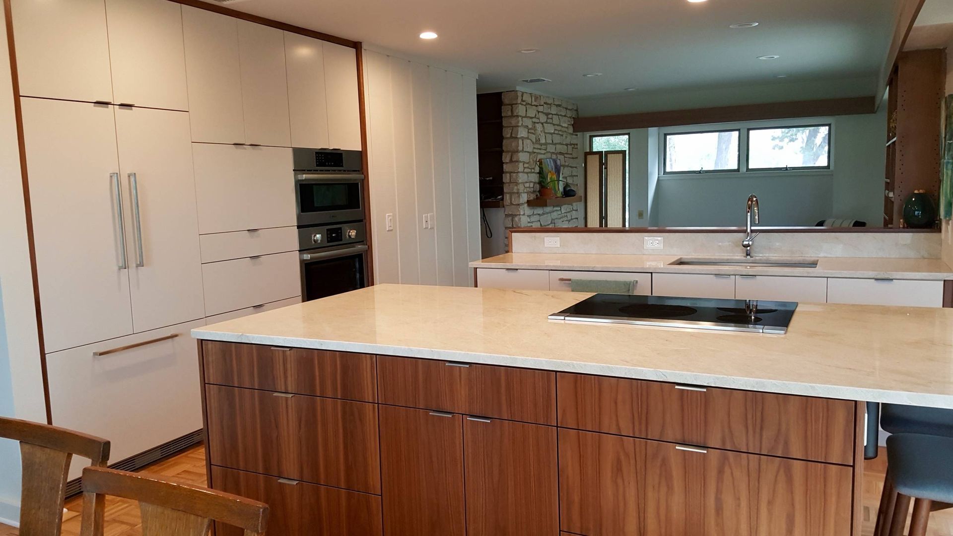 A kitchen with a large island and a stove top oven.