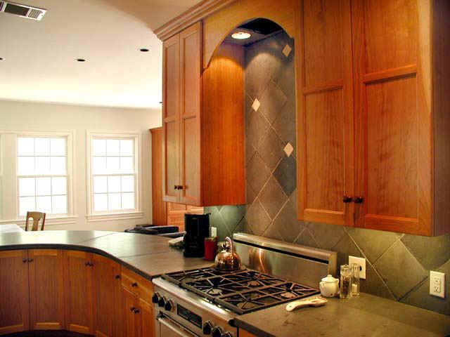 A kitchen with wooden cabinets and a stove top oven