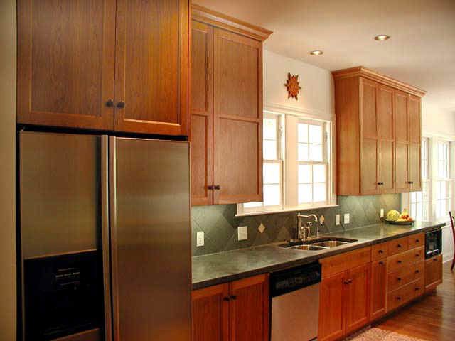 A kitchen with stainless steel appliances and wooden cabinets