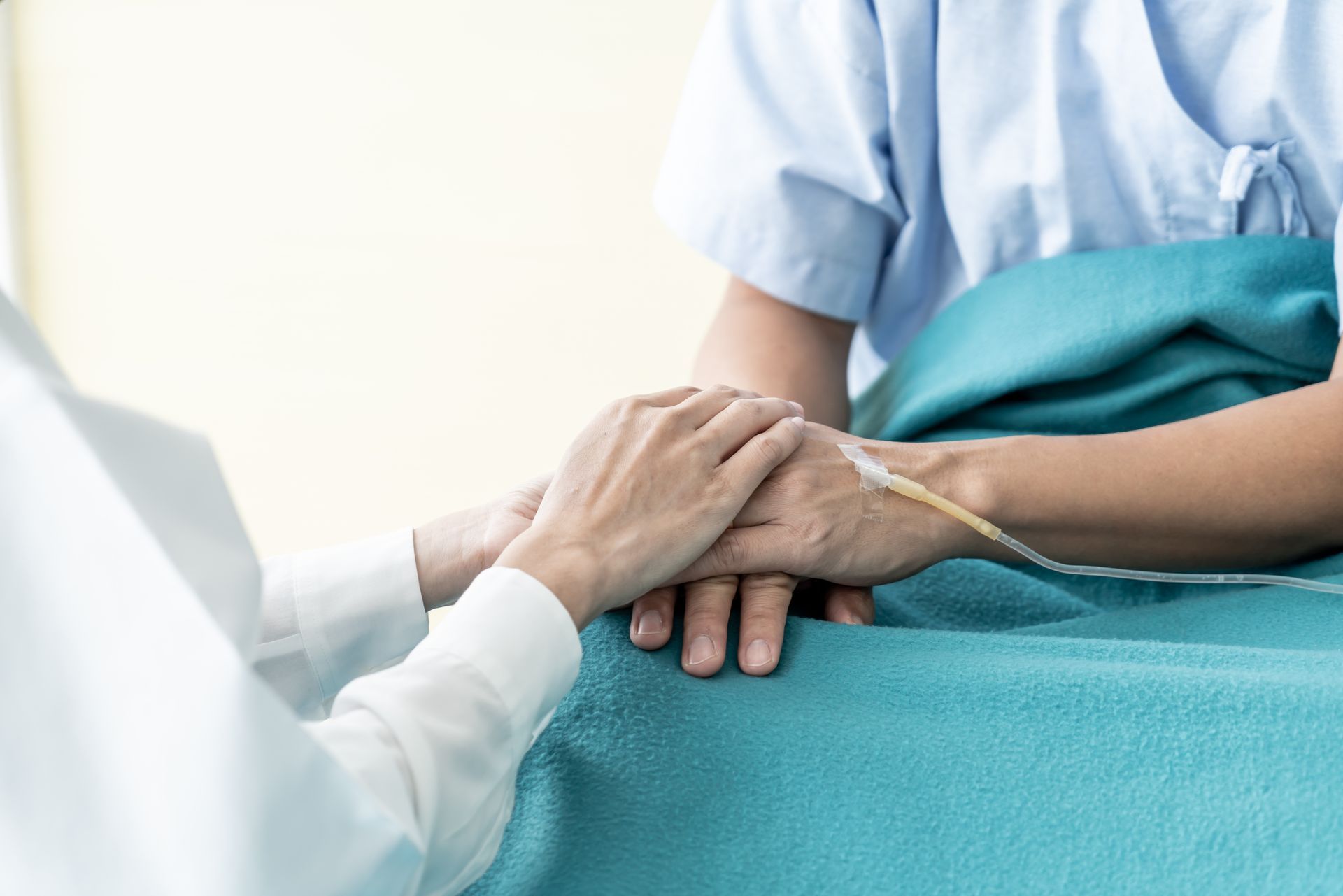 Doctor holding a patient's hand, representing guardianship and conservatorship in Washington.
