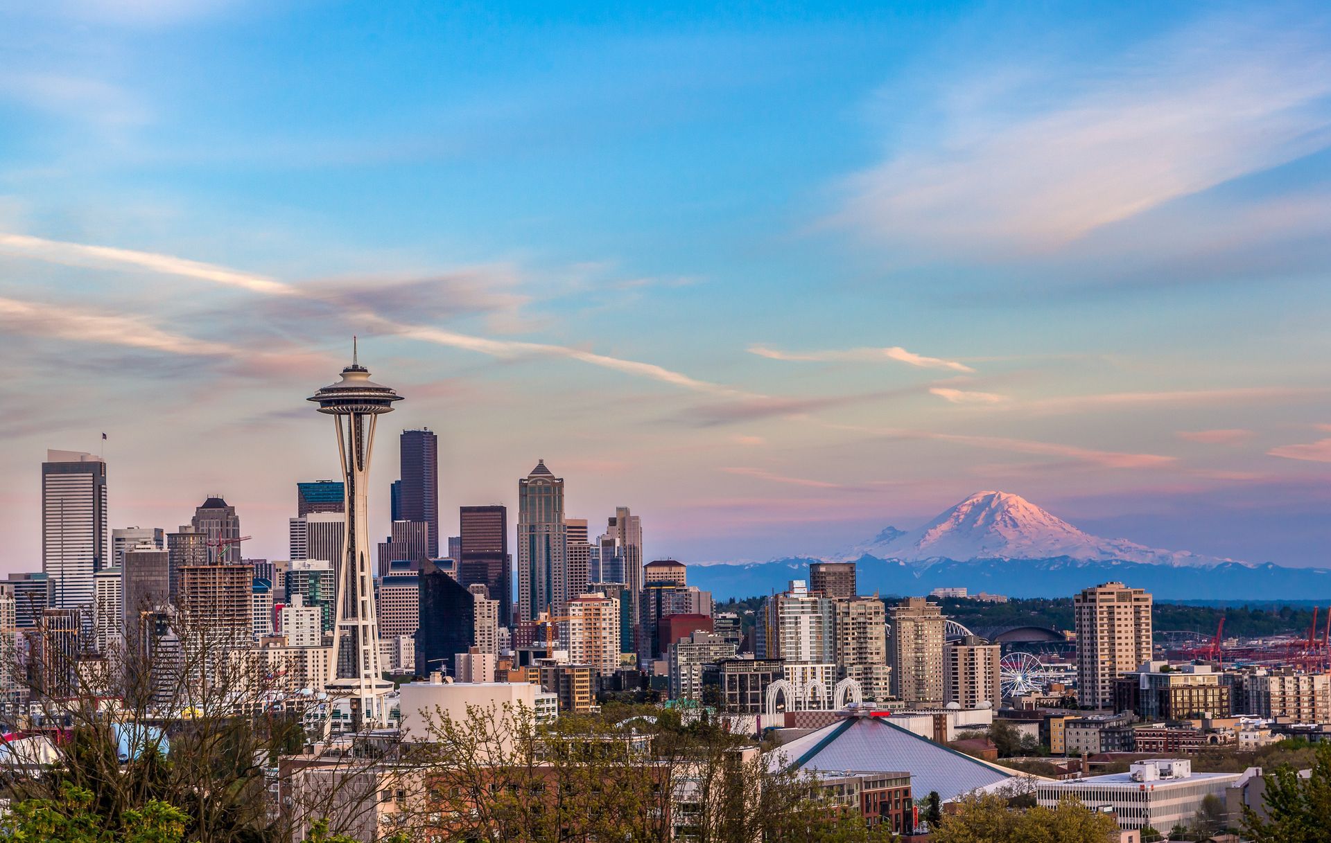 A city skyline with a mountain in the background.