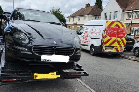 black car on the back of a pick-up lorry