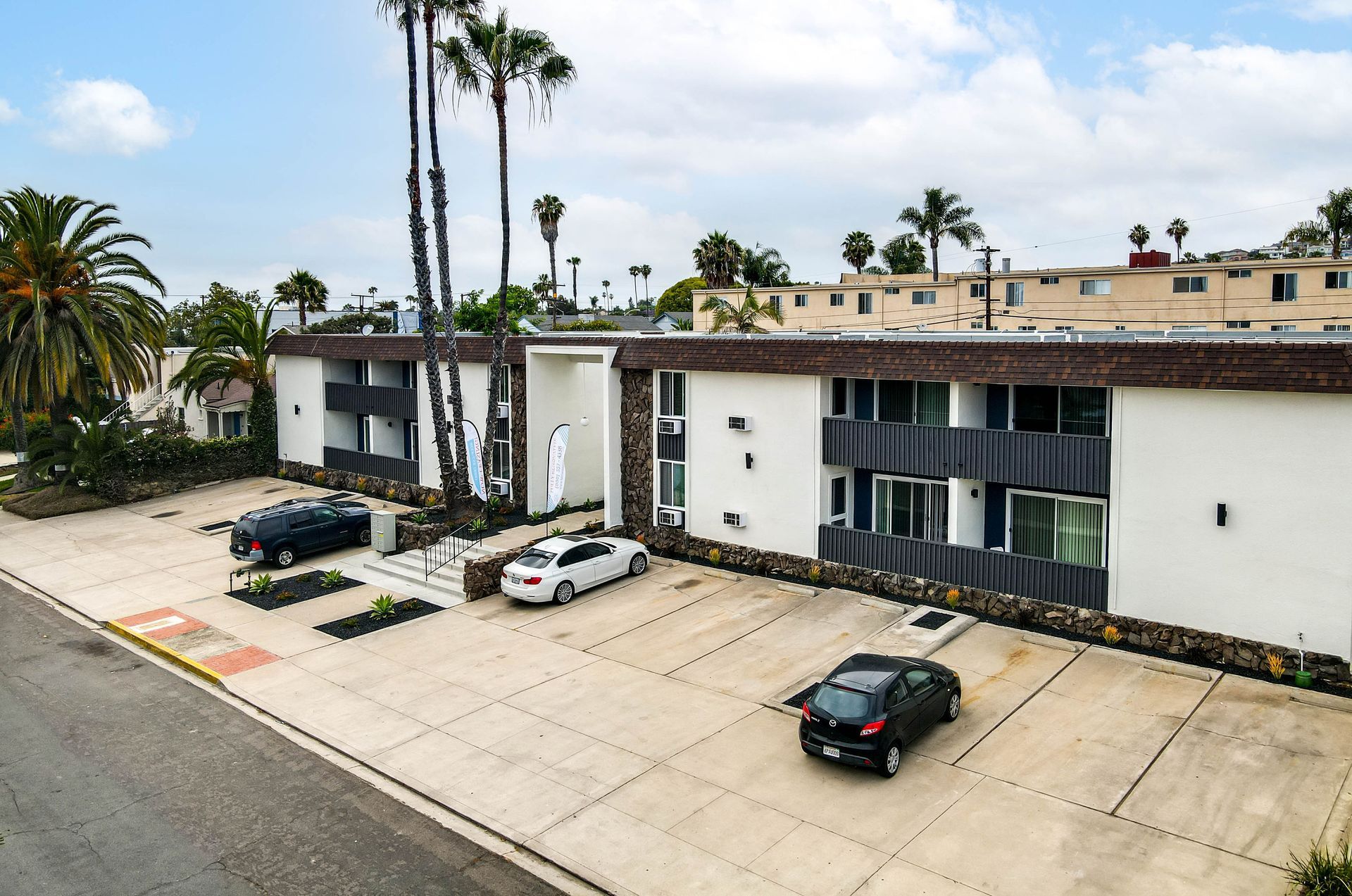 An aerial view of a building with cars parked in front of it