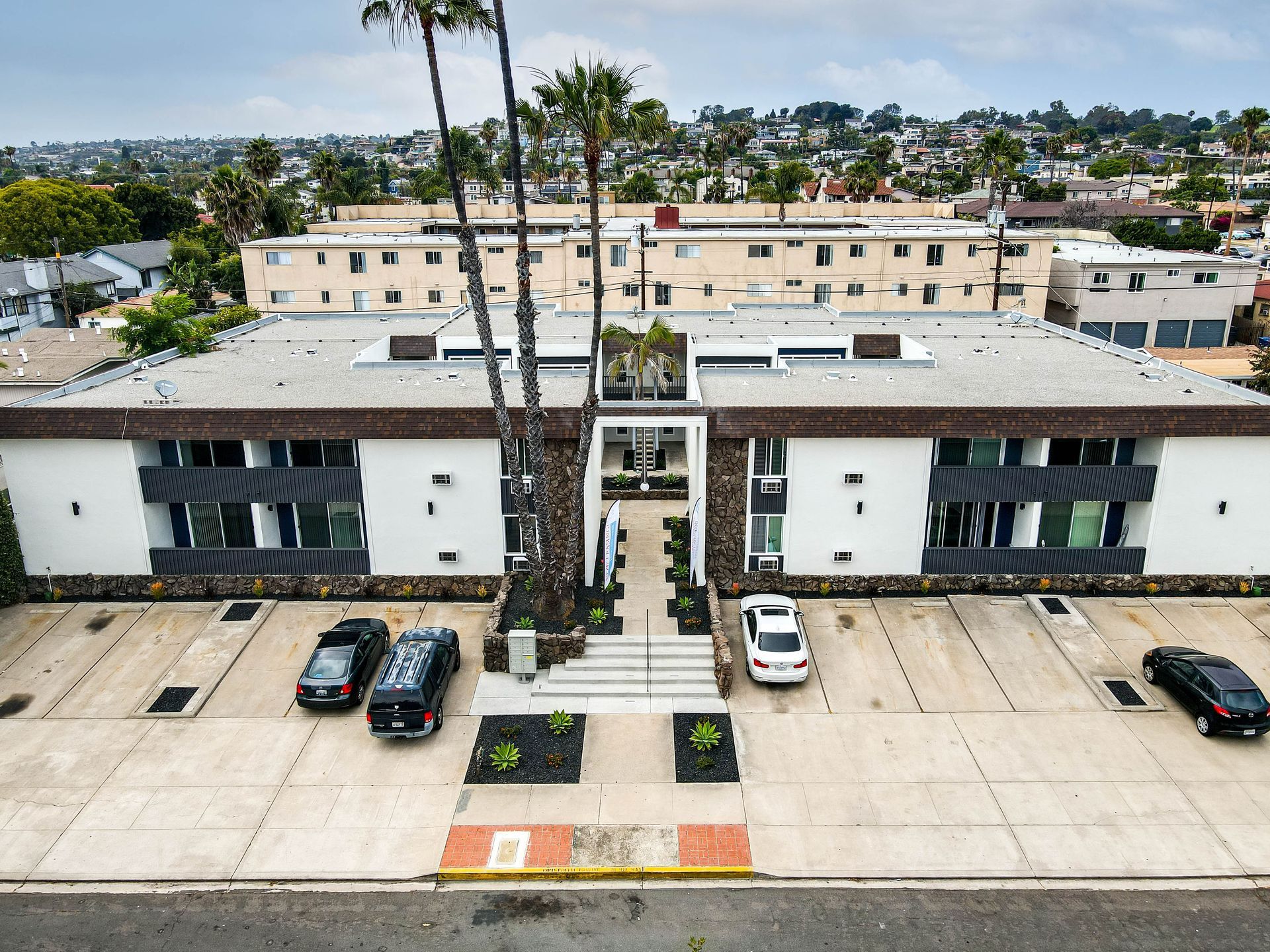 An aerial view of a building with cars parked in front of it