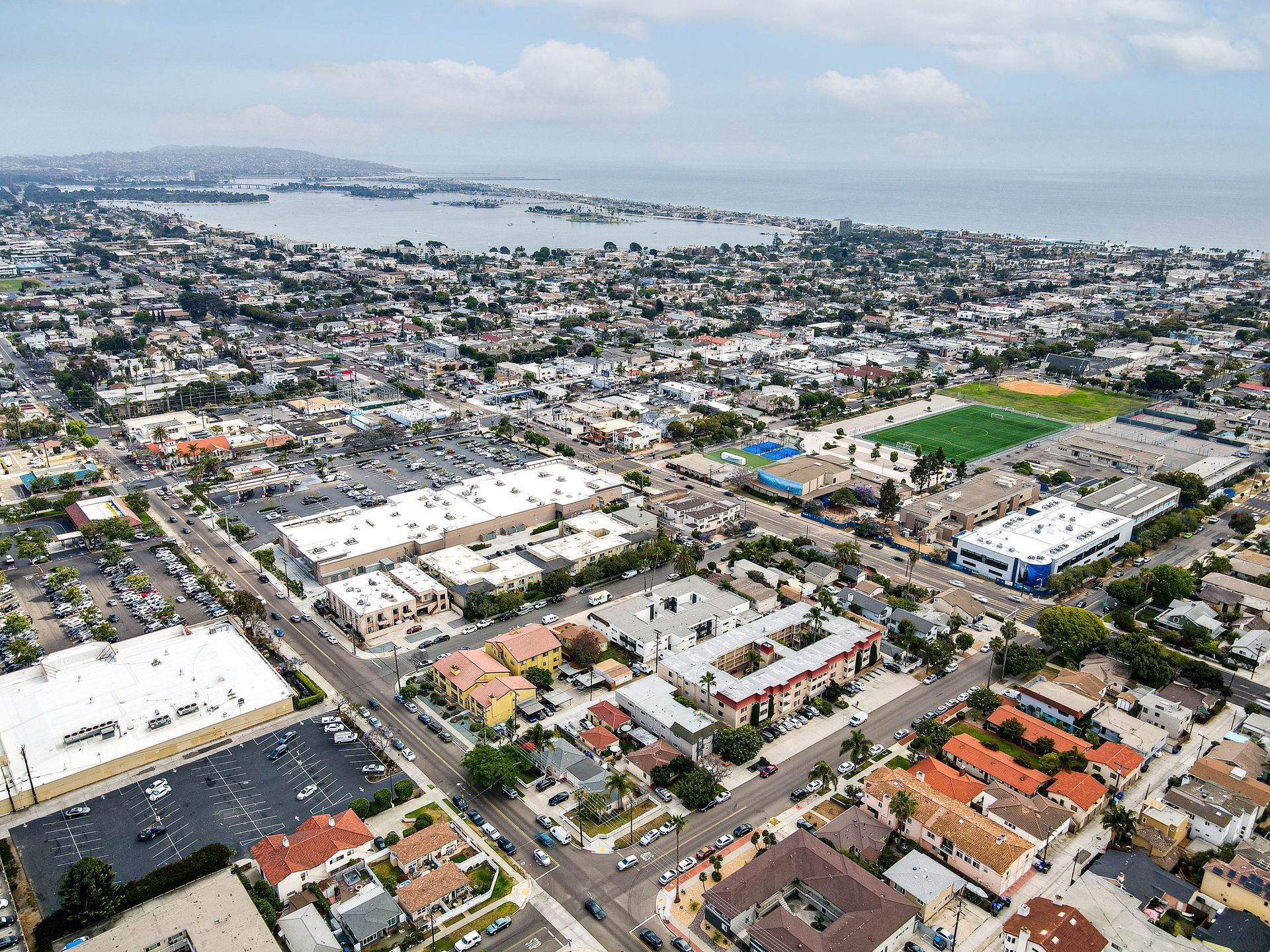 An aerial view of a city with a large body of water in the background.