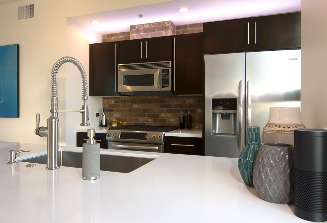 A kitchen with stainless steel appliances and a sink