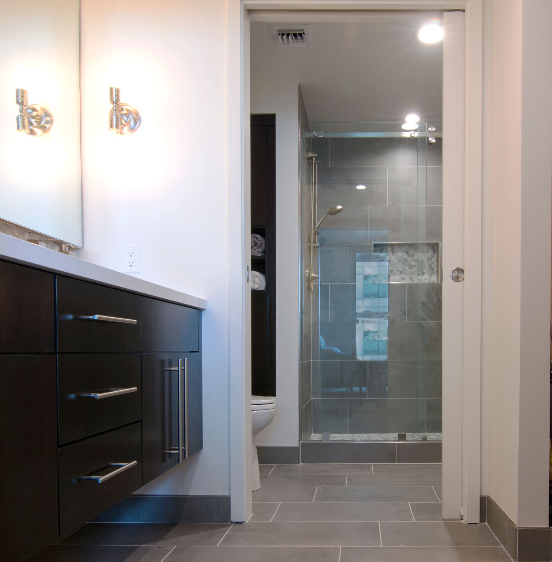 A bathroom with a toilet and a walk in shower