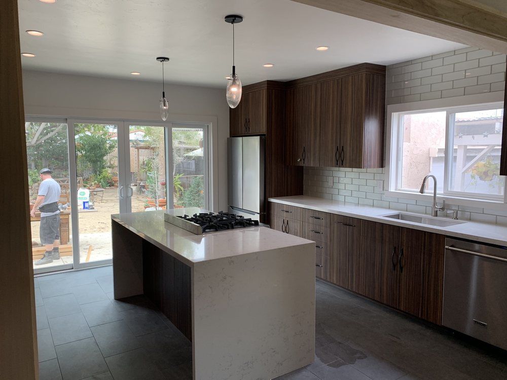 A kitchen with a large island in the middle of it.