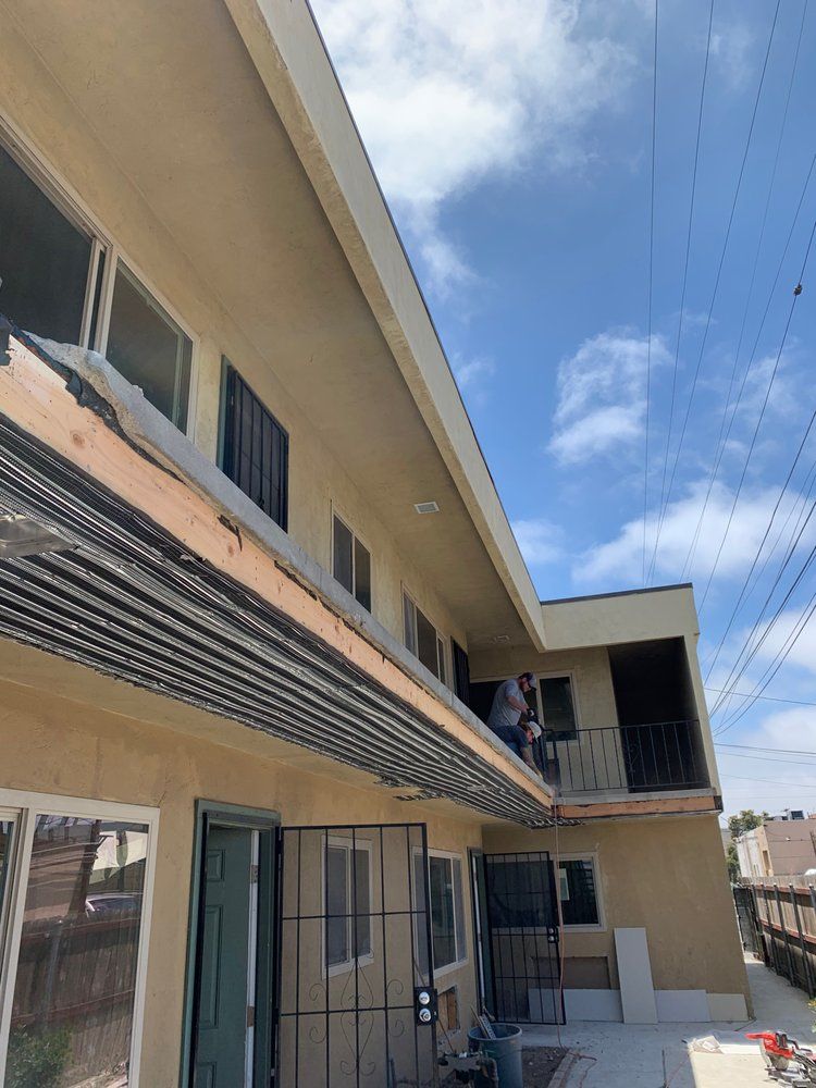 A man is standing on the roof of a building.