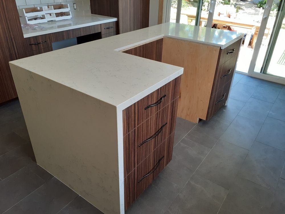 There is a large island in the middle of the kitchen.