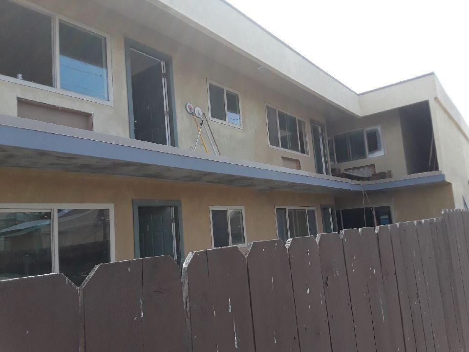 A building with a wooden fence in front of it