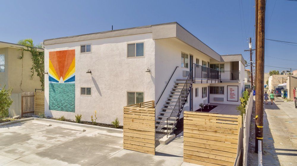 An aerial view of a building with a mural on the side of it.