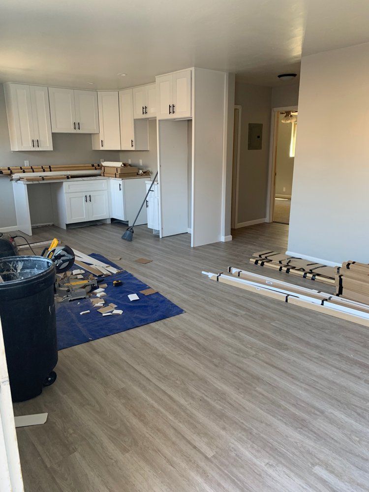 A living room and kitchen are being remodeled in a house.
