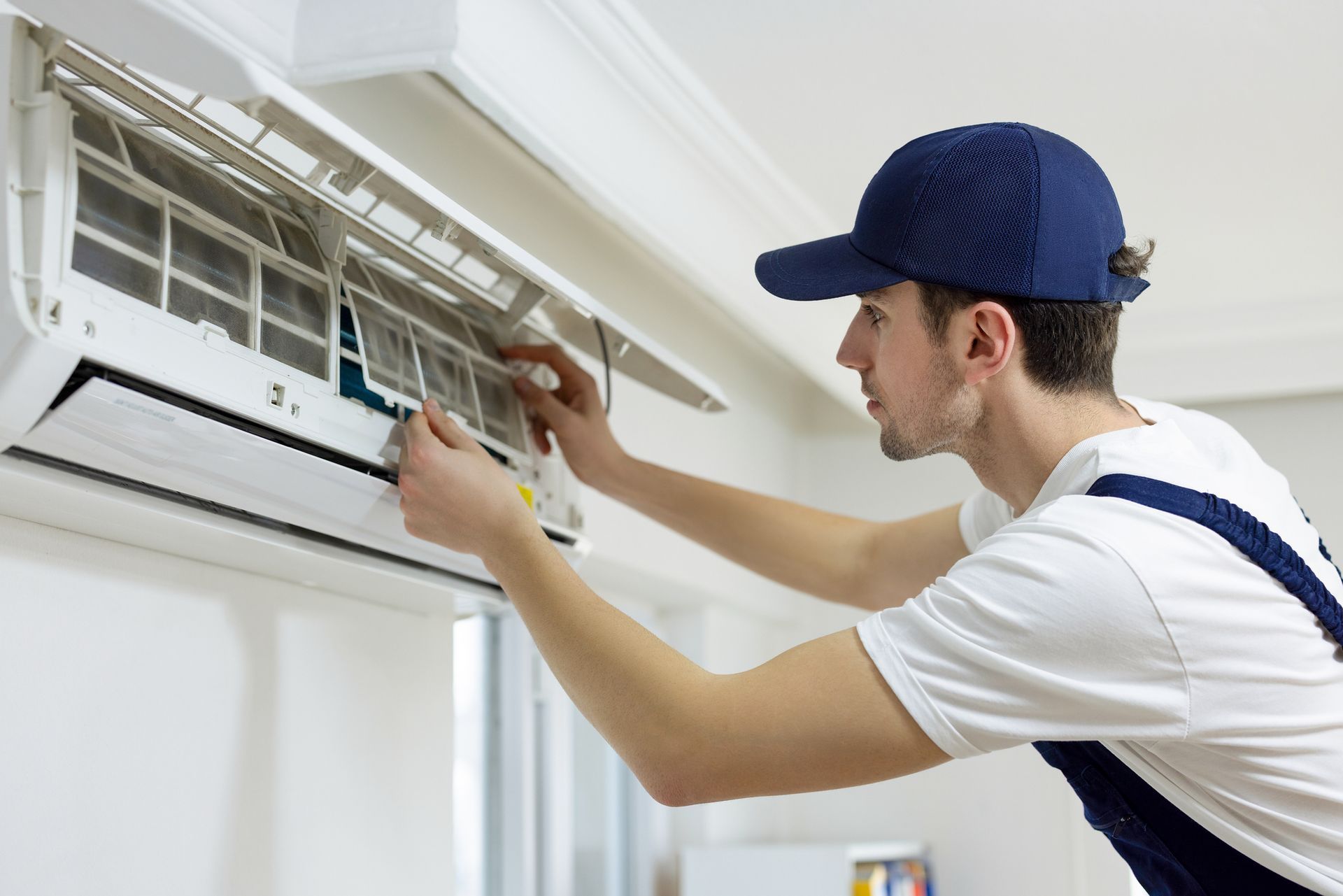 Air conditioning services technician repairing central air conditioner. Air conditioning services technician repairing central air conditioner.