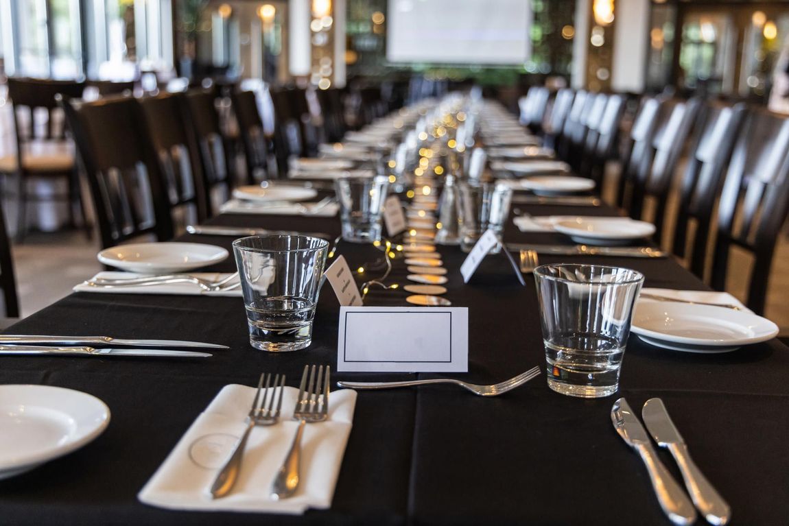 Long Table With Plates and Glasses for Corporate Event