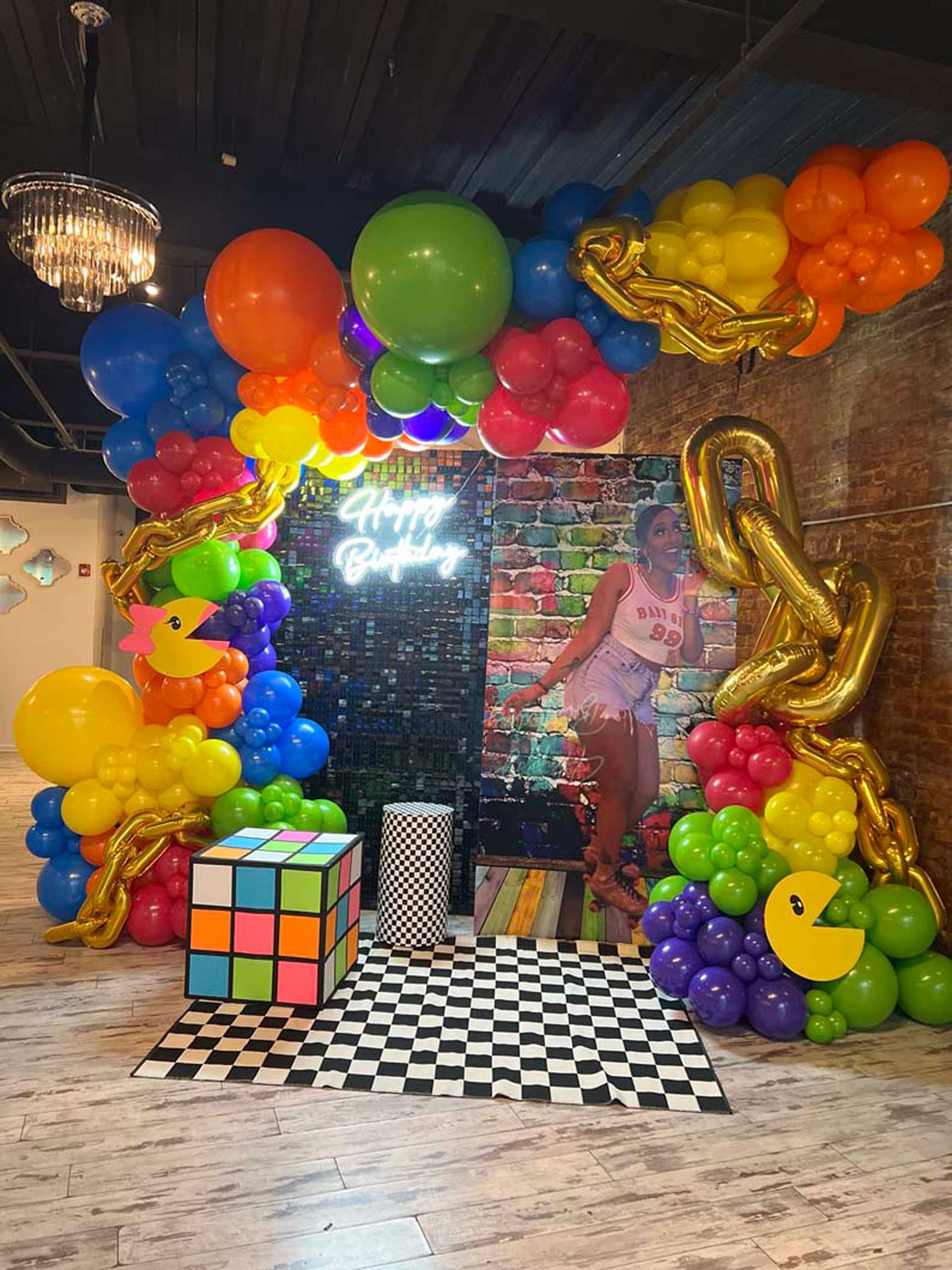 A room filled with balloons and a picture of a woman