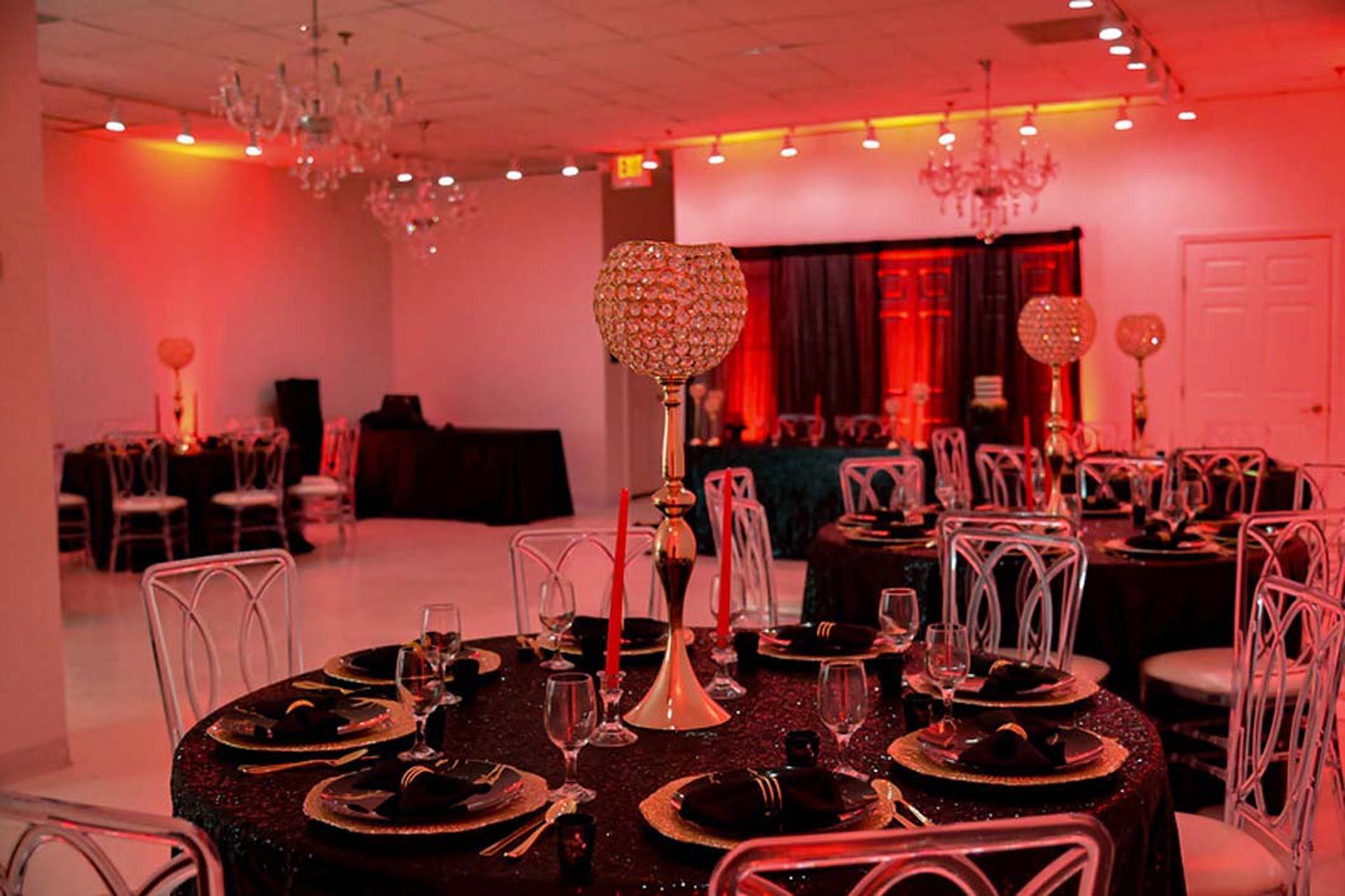 A large room with tables and chairs set up for a party