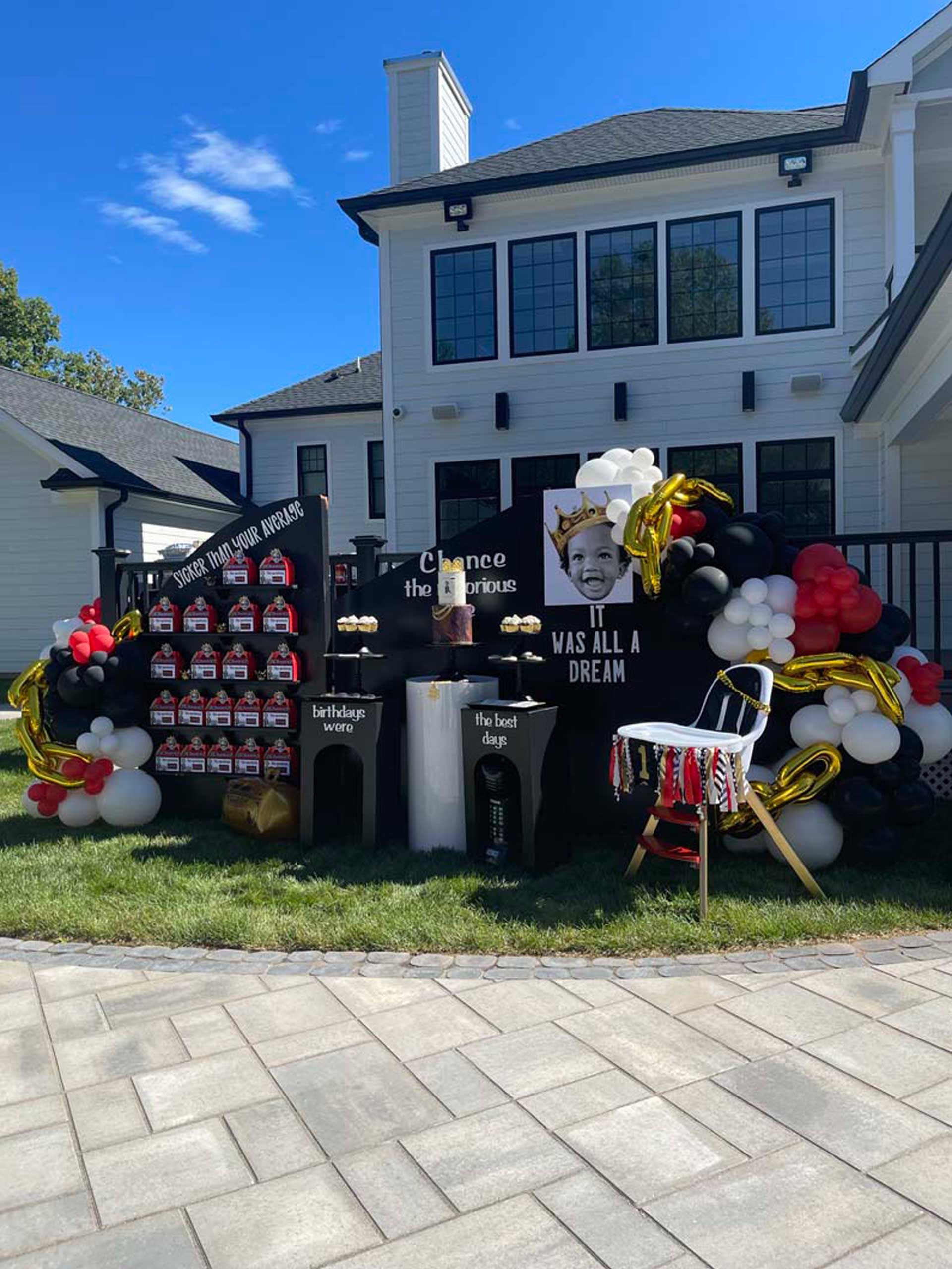 A large house with a lot of balloons in front of it