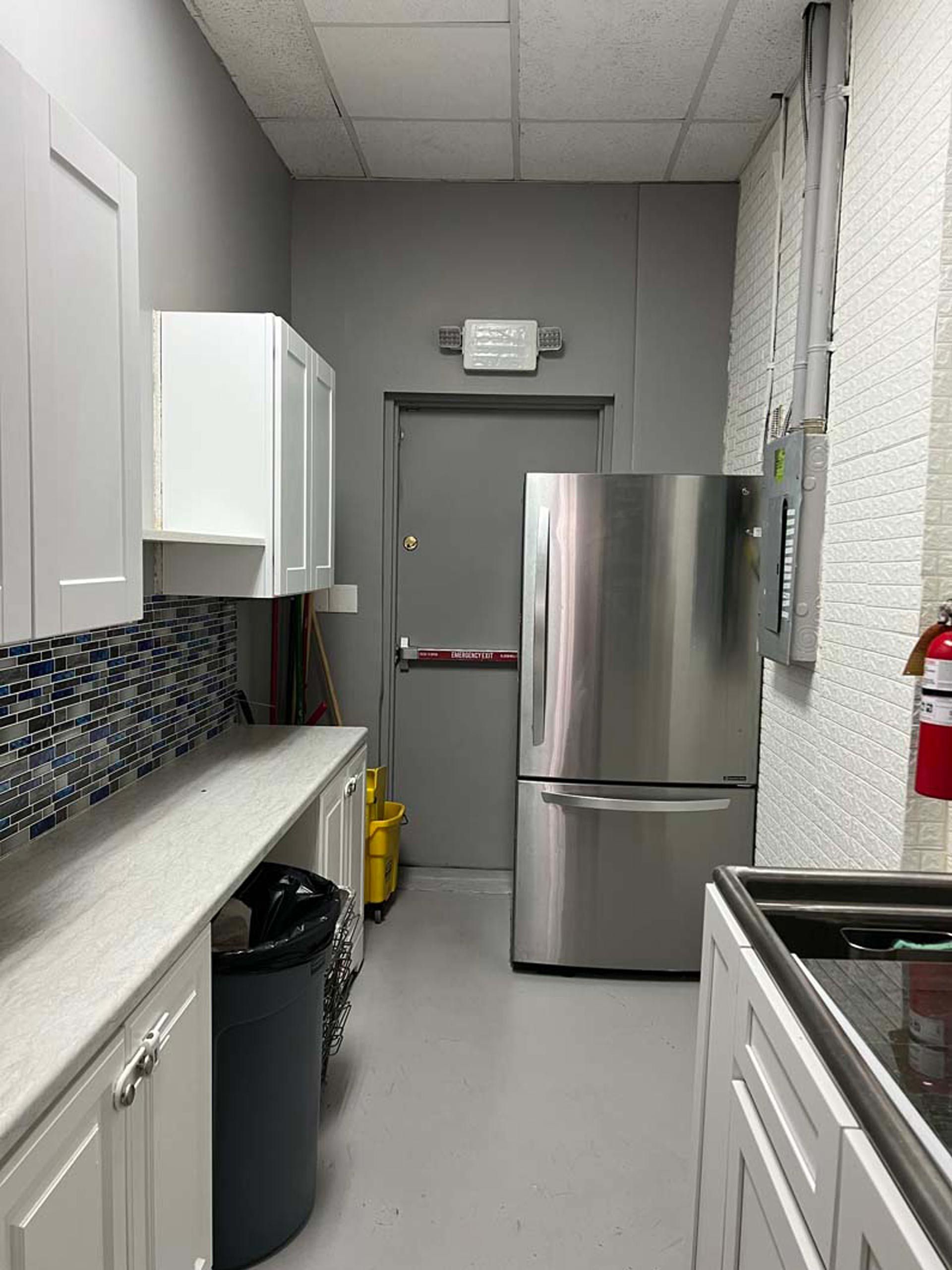 A kitchen with stainless steel appliances and white cabinets