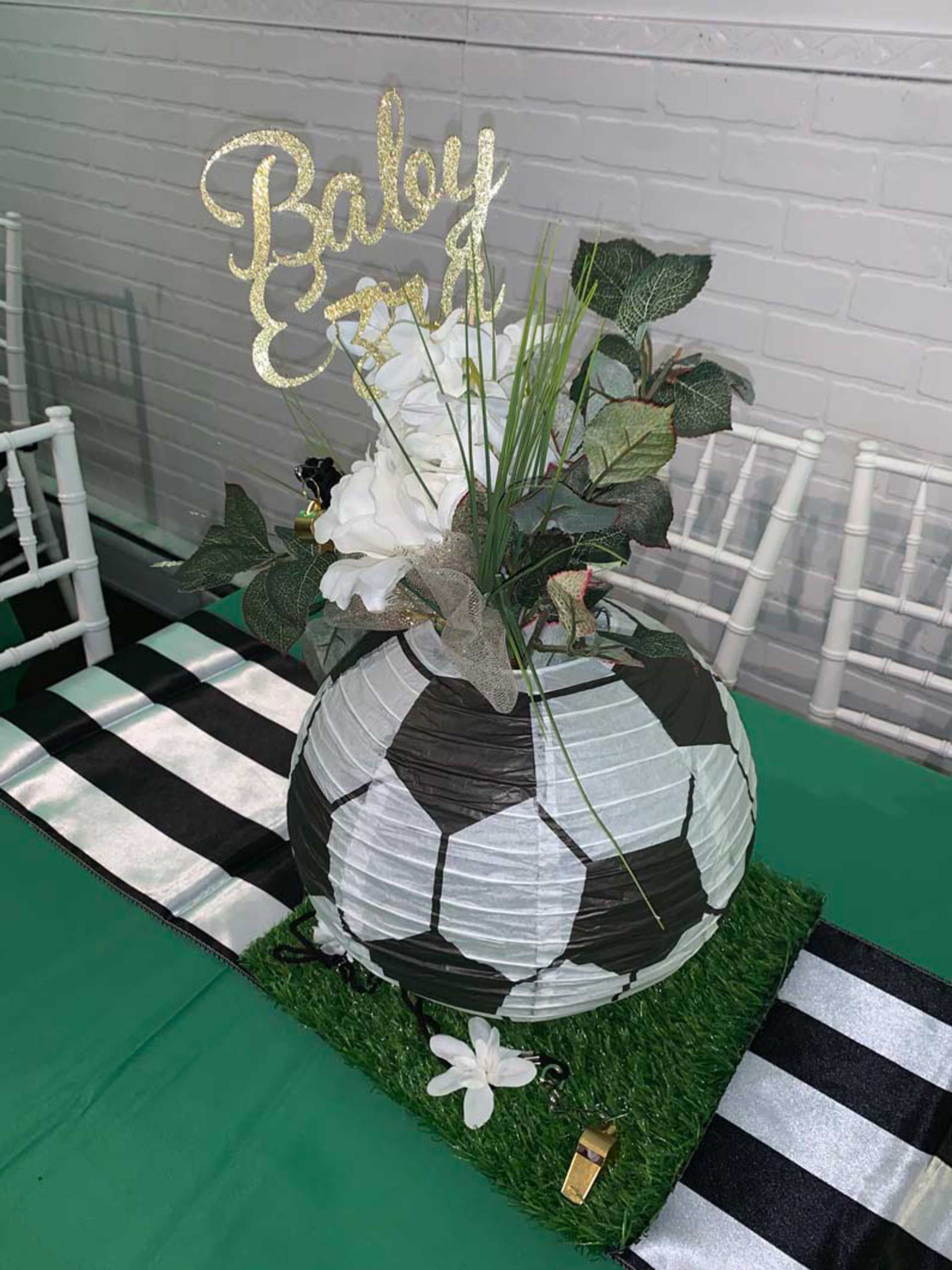 A soccer ball with flowers in it is on a table