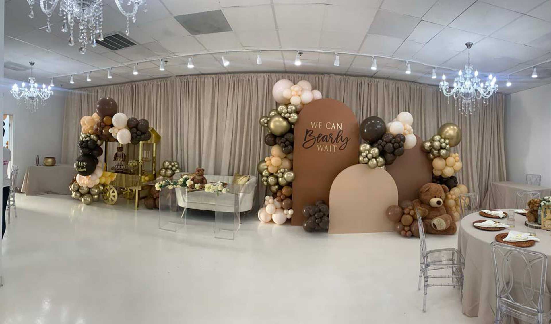 A large room decorated with balloons and teddy bears for a baby shower