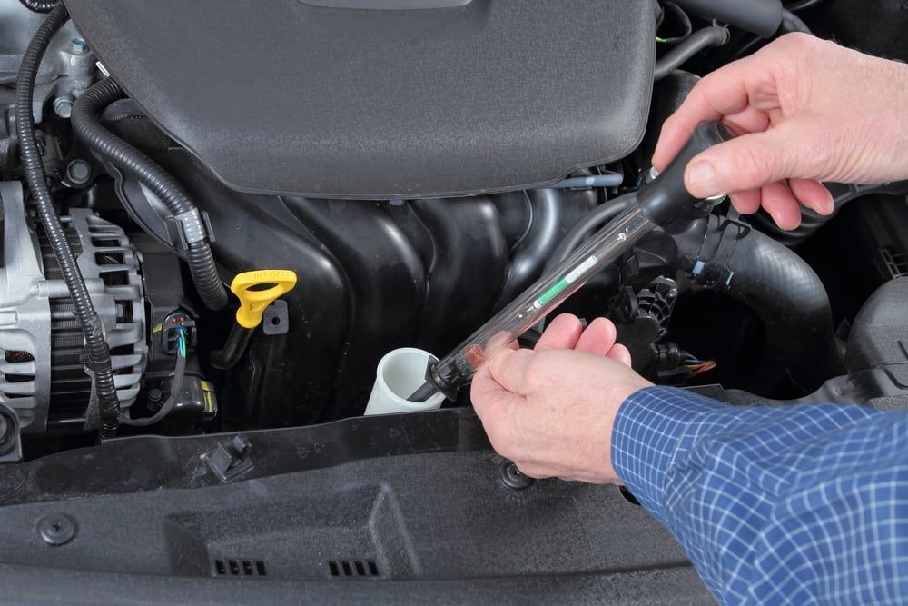 A Person is Working on a car Engine with a Wrench — Edgy Car Mechanics in Edgeworth, NSW