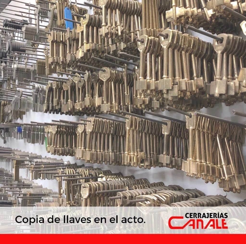 Wall display of many metal keys for copying. 