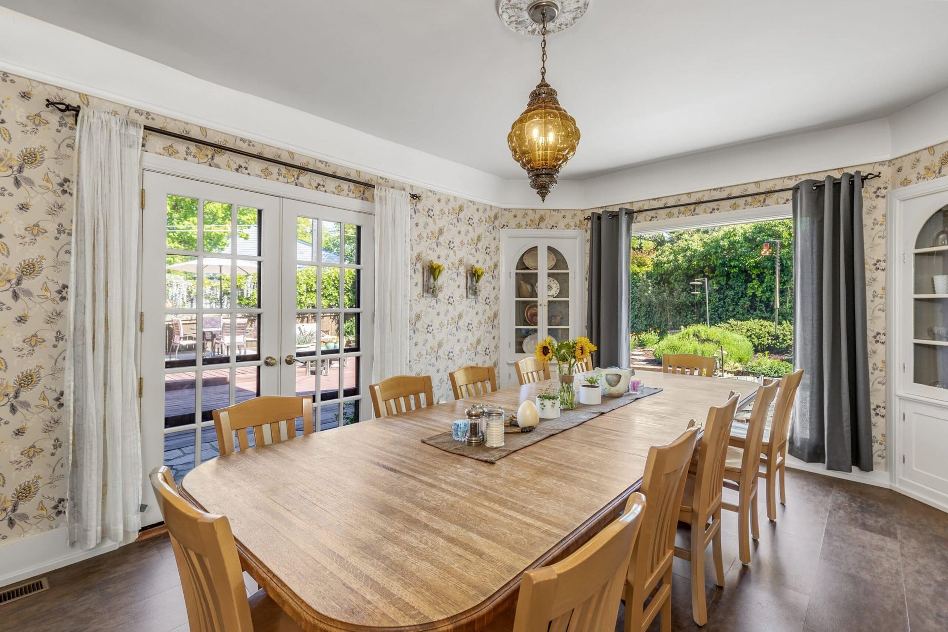 A dining room with a long wooden table and chairs