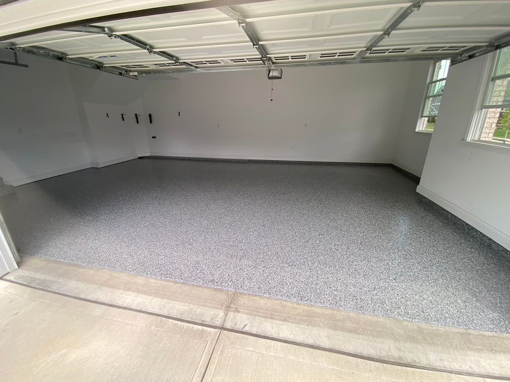 Woman in straw hat smiles, holding wine glass near a lake.