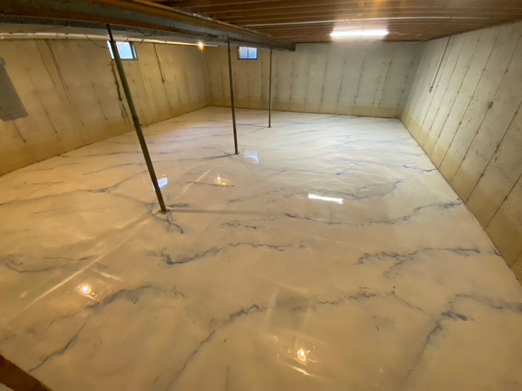 Woman in straw hat smiles, holding wine glass near a lake.