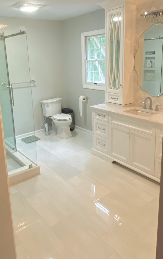 A bathroom with a toilet , sink , and shower.