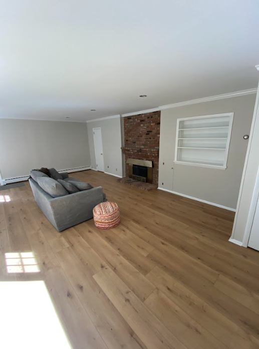A living room with a couch and a fireplace.