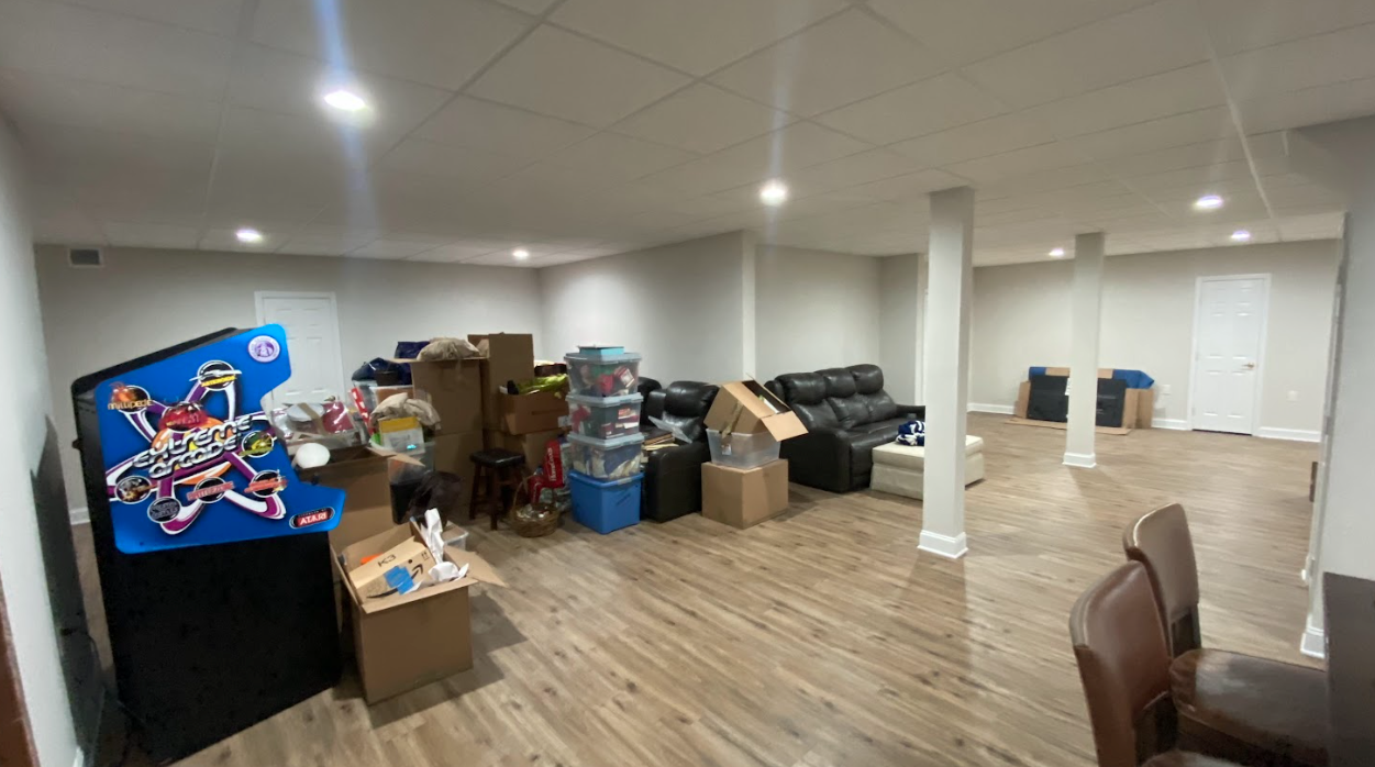 A basement filled with lots of boxes and a couch.
