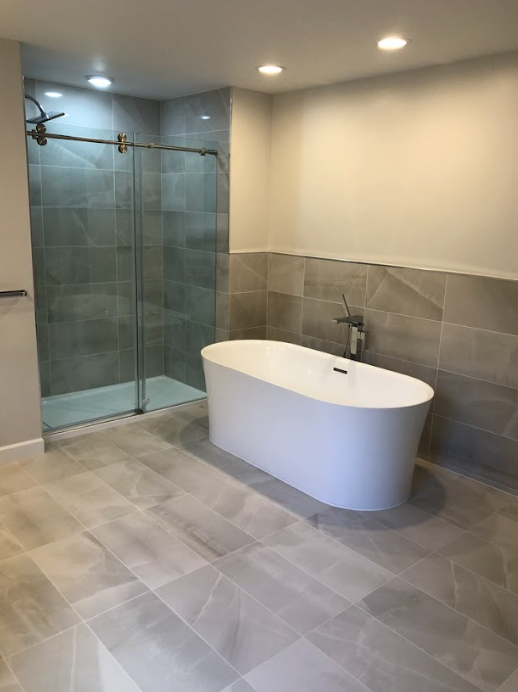 A bathroom with a bathtub and a walk in shower.