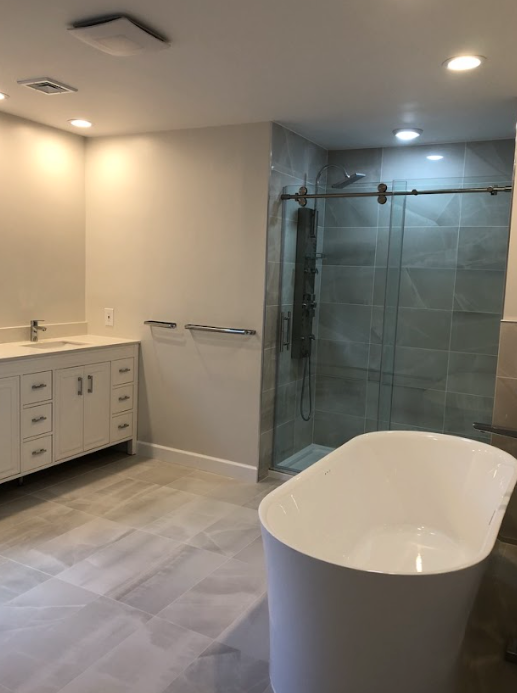 A bathroom with a bathtub and a walk in shower.