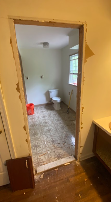 A bathroom with a toilet and a window is being remodeled.