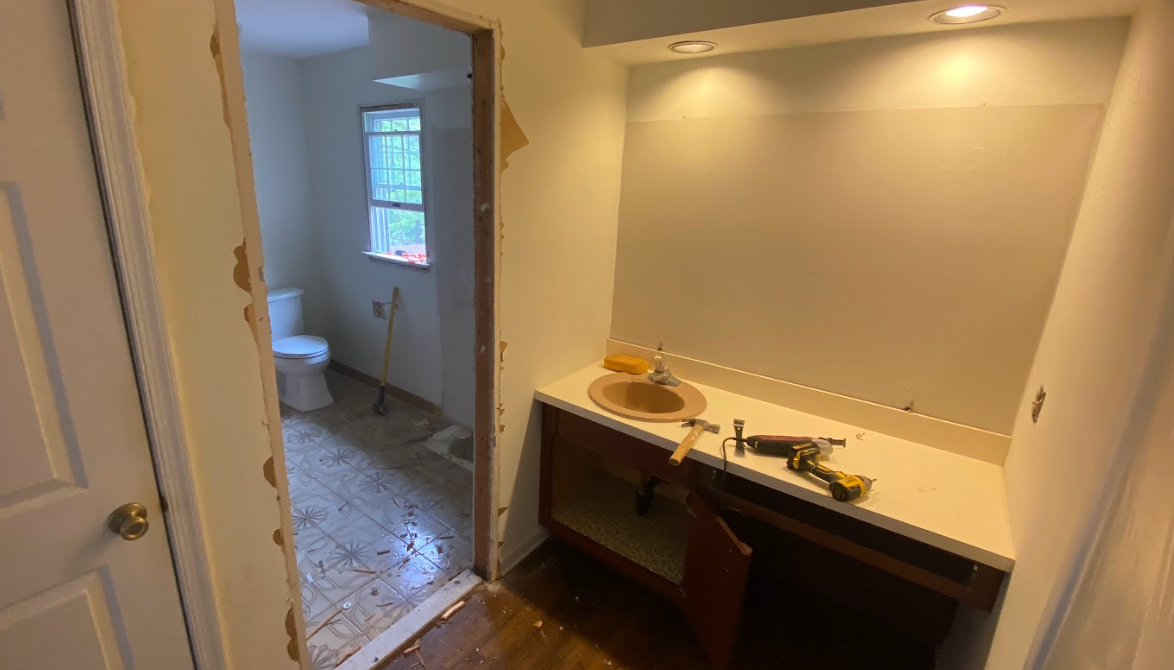 A bathroom with a sink and a toilet in it.