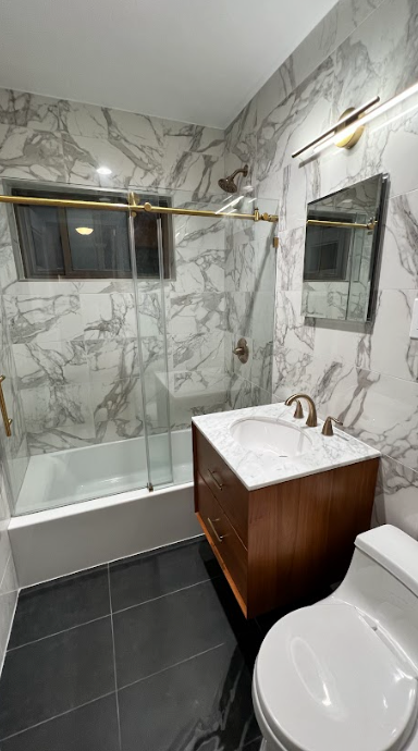 A bathroom with a toilet , sink , and shower.