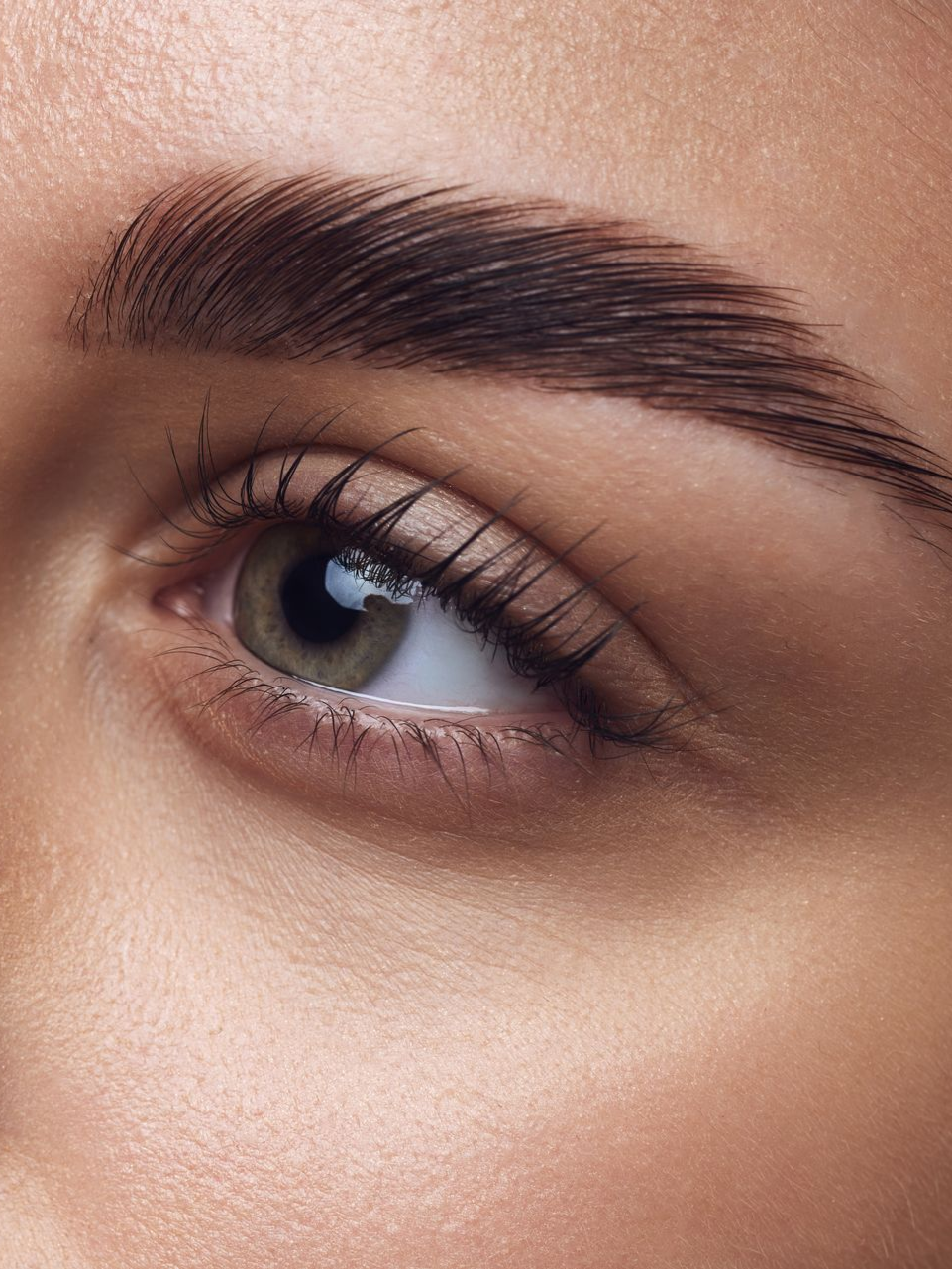 Close up of womens eye wearing mascara and eyebrows laminated