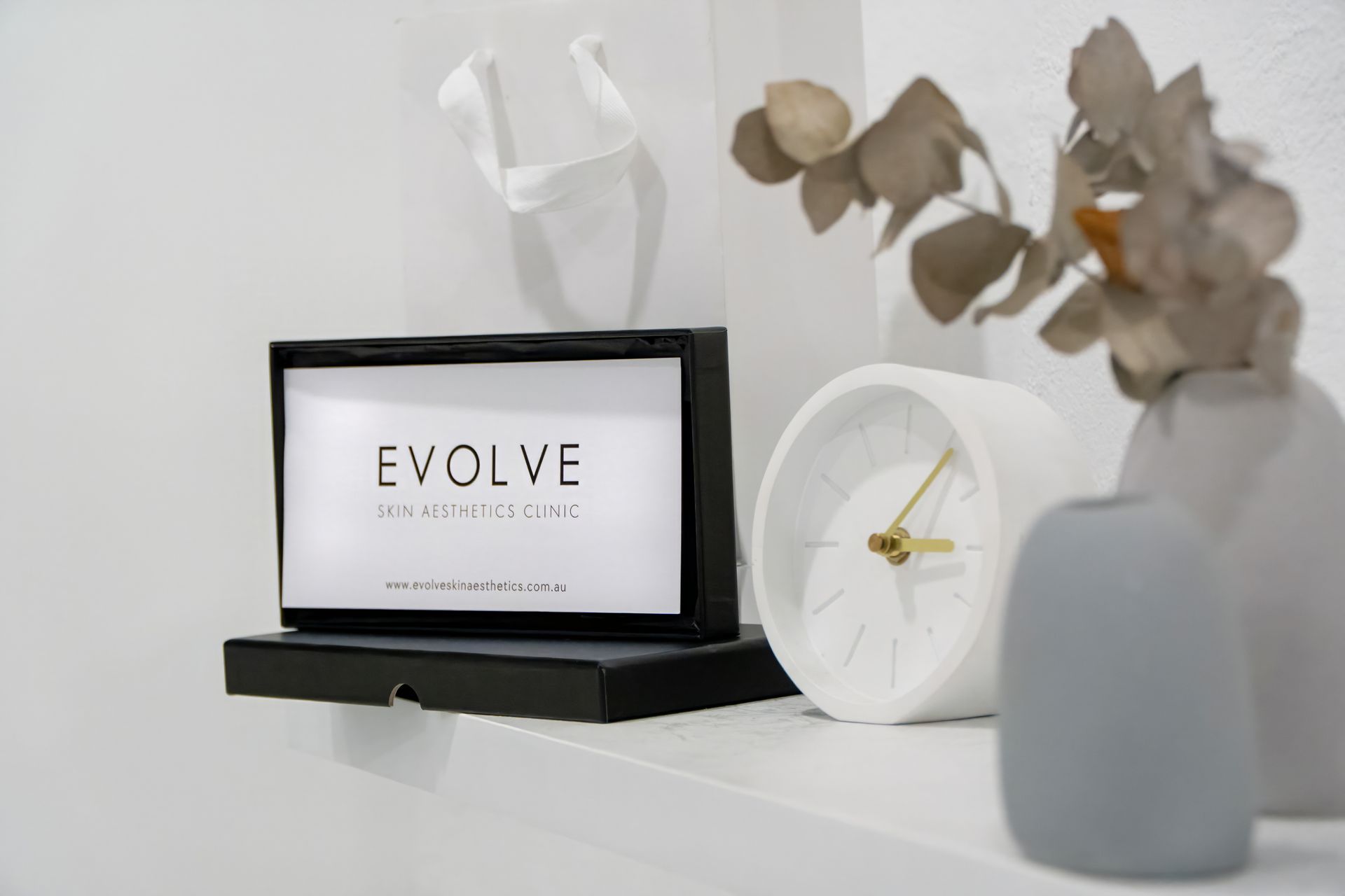 Woman with hair towel on head receiving facial treatment