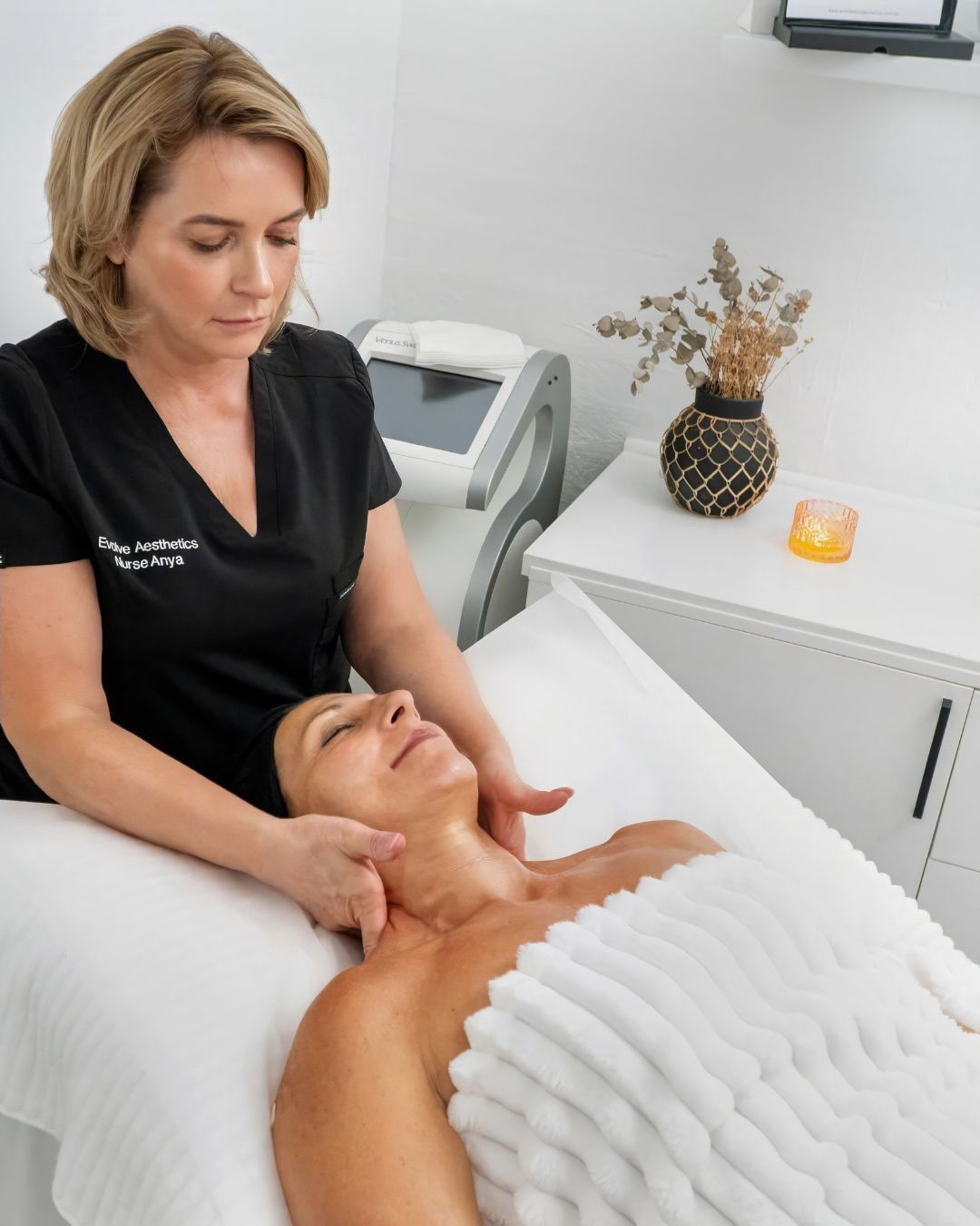Woman holding mirror up reviewing cosmetic treatment