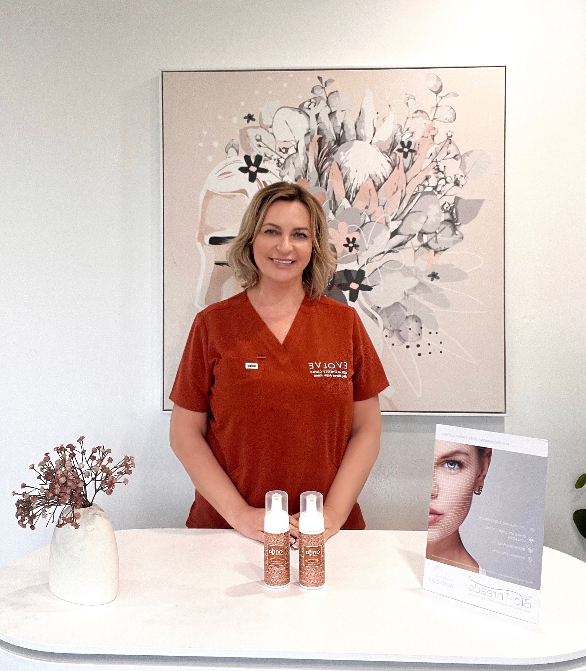Woman feeling face with hand with hair towel covering hair