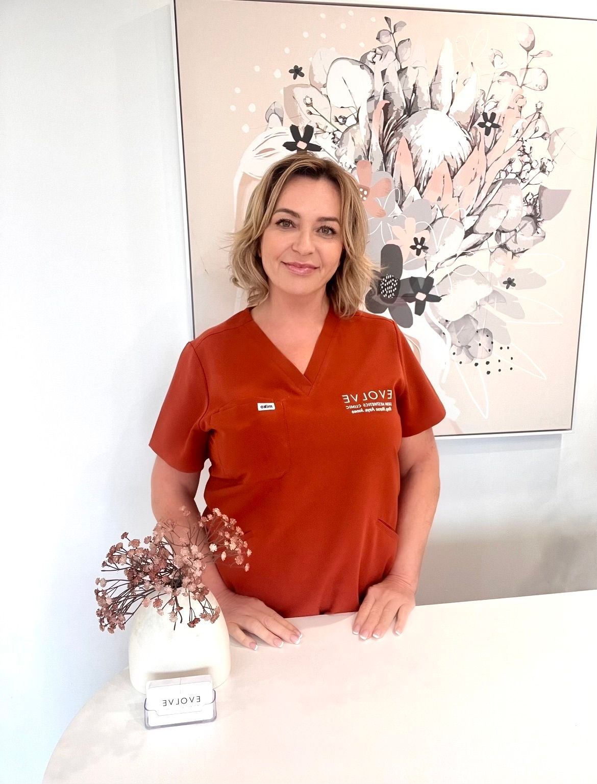 Woman holding hands on face with hair slicked back