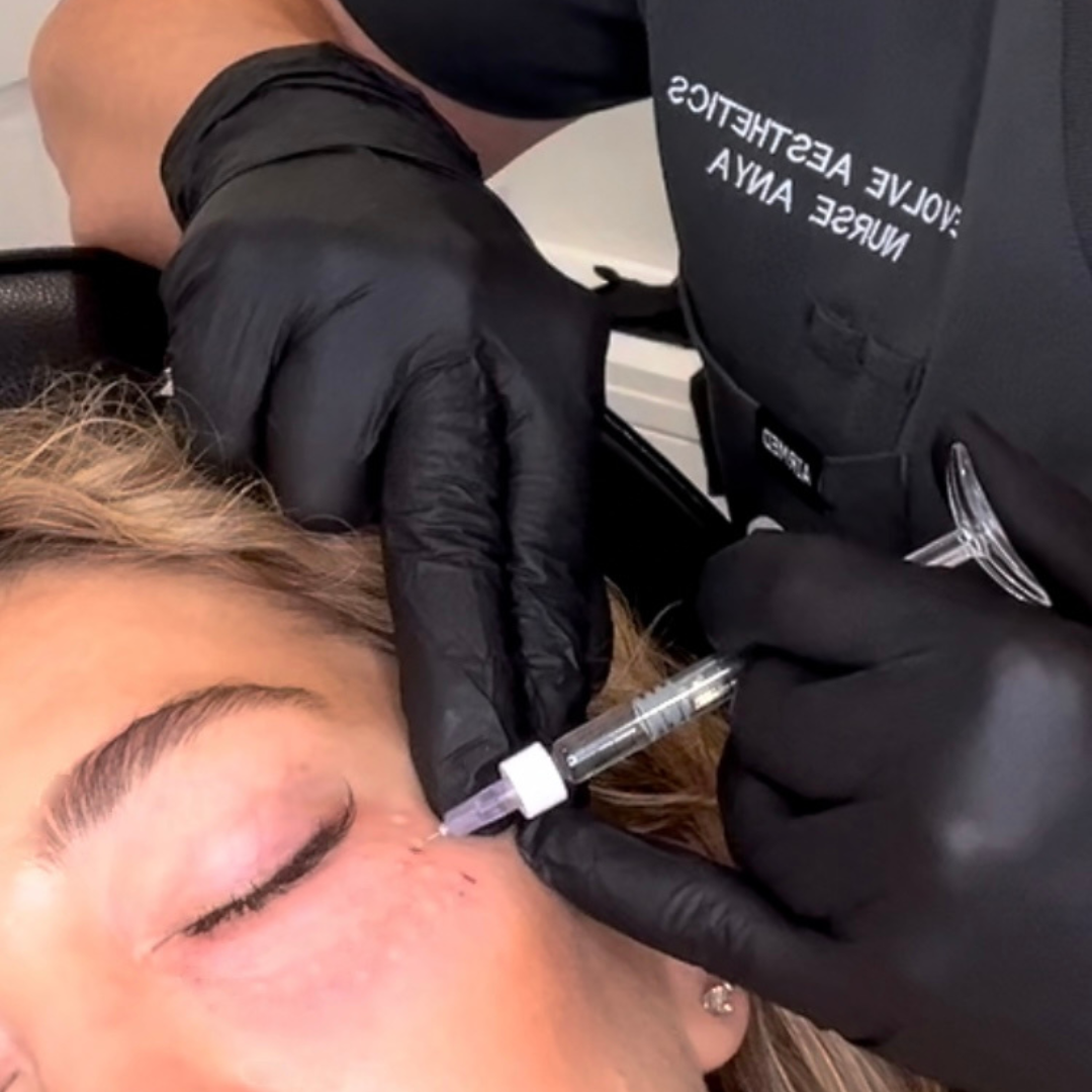 Woman sitting in white chair with mirror on wall